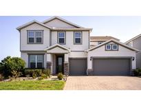 Beautiful two-story home featuring a manicured lawn and a two-car garage, offering curb appeal and ample parking at 2539 Auburn Ridge Dr, Apopka, FL 32712