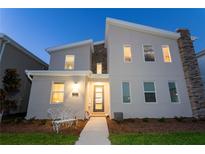 Charming two-story home with modern architectural details, beautiful stone accents and a welcoming walkway at 2836 Simile St, Kissimmee, FL 34746
