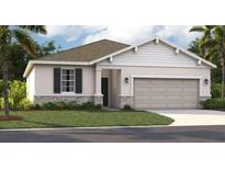 Charming one-story home featuring a two-car garage, classic shutters, manicured lawn and stone accents at 439 Shoreview Sands Ave, Mascotte, FL 34753