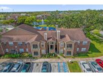 Beautiful exterior view of the complex with a fountain and well-manicured landscaping at 4400 Thornbriar Ln # 104, Orlando, FL 32822