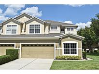 Two story home featuring a two car garage, well maintained lawn, and manicured landscaping at 506 Harbor Winds Ct, Winter Springs, FL 32708