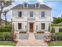 Elegant white two-story home with symmetrical windows, shutters, and landscaped front yard at 541 W Canton Ave, Winter Park, FL 32789