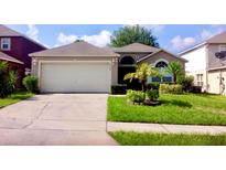 Charming single-story home with a well-maintained lawn and a two-car garage at 6704 Westlake Blvd, Orlando, FL 32810