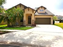 Charming single-Gathering home featuring manicured landscaping, a circular driveway and a two-car garage at 6728 Duncaster St, Windermere, FL 34786