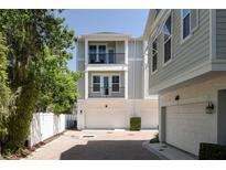 Charming three-story townhome showcasing a two-car garage and dual balconies at 117 E Concord St # 7, Orlando, FL 32801