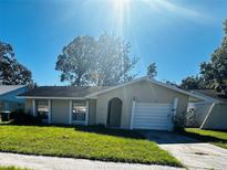 Charming single-story home featuring a manicured lawn and a one car garage at 117 N Alderwood St, Winter Springs, FL 32708
