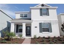 Charming two-story home with symmetrical design, dark shutters, and inviting entrance at 11834 Epic Ave, Orlando, FL 32832