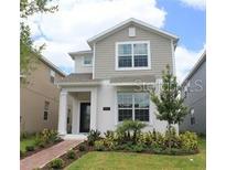 Charming two-story home featuring neutral colors, a landscaped yard and a welcoming walkway at 11941 Sonnet Ave, Orlando, FL 32832