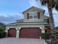 Charming two-story home with a three car garage and well-maintained landscaping at 12610 Sawgrass Oak St, Orlando, FL 32824