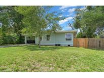 Charming single story home with a well-maintained lawn and mature trees, offering great curb appeal at 1881 Cottonwood St, Orange City, FL 32763