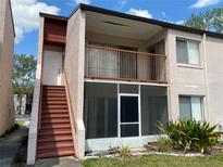 Charming condo with an outdoor balcony, screened-in porch, and inviting staircase leading to the entrance at 2468 Citrus Club Ln # 502, Orlando, FL 32839