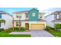 Charming two-story home featuring a well-manicured lawn, two palm trees, and a welcoming entrance at 266 Marcello Blvd, Kissimmee, FL 34746