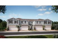 Charming townhome showcasing modern architecture, a private garage, and beautifully landscaped surroundings at 354 Thompson Village Ave, Apopka, FL 32703