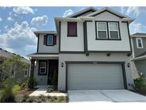 Charming two-story home boasts a two-car garage, landscaped front yard, and a welcoming facade at 6268 Great Bear Dr, Lakeland, FL 33805