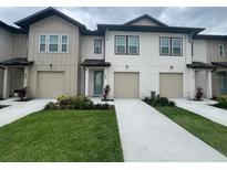 Charming townhomes feature a well-manicured lawn and convenient attached garages at 639 Longboat Dr, Davenport, FL 33896