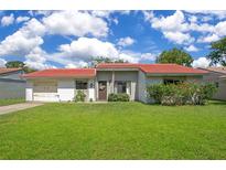 Charming single-story home featuring a well-manicured lawn and vibrant red-tiled roof at 10148 Eventide Ct, Orlando, FL 32821