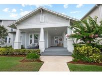 Charming home featuring a inviting covered porch, craftsman details and a beautifully landscaped front yard at 1212 Civitas Way, Winter Garden, FL 34787