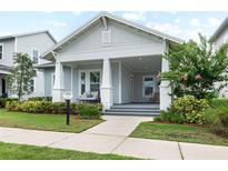 Charming single-story home featuring a welcoming front porch with elegant columns and well-maintained landscaping at 1212 Civitas Way, Winter Garden, FL 34787