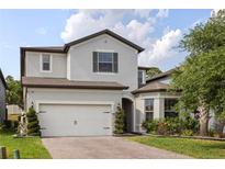 Charming two-story home featuring a brick driveway, two-car garage, and well-manicured landscaping at 1272 Patterson Ter, Lake Mary, FL 32746