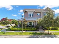 Charming two-story home boasts manicured landscaping, a metal roof and a welcoming front porch at 13661 Granger Ave, Orlando, FL 32827