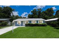Charming single-story home featuring a lush green lawn, neat landscaping, and a freshly painted exterior at 1507 Sw 4Th St, Ocala, FL 34471