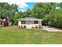 Charming home featuring a well-maintained lawn and manicured garden beds at 1906 S Summerlin Ave, Sanford, FL 32771