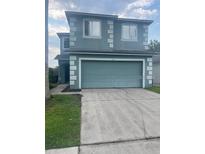 Two-story home with a two-car garage and well-maintained lawn at 1921 Stone Abbey Blvd, Orlando, FL 32828