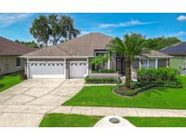 Beautiful single-story home boasts a well-manicured lawn, landscaping, and a two-car garage at 2643 University Acres Dr, Orlando, FL 32817