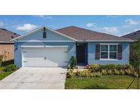 Charming single-Gathering home showcasing a well-manicured lawn and attached two car garage at 3354 Aruba Way, Haines City, FL 33844