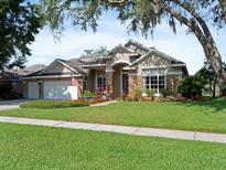 Charming single-story home with stone accents, manicured lawn, and a two-car garage in a well-maintained neighborhood at 3840 Caledonia Ave, Apopka, FL 32712