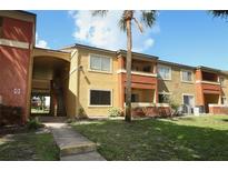 Inviting condo exterior featuring well-maintained landscaping, warm tones, and a welcoming entrance at 662 Kenwick Cir # 102, Casselberry, FL 32707