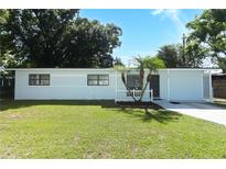 Charming single-story home with well-manicured lawn, mature trees, and a welcoming front entrance at 707 N Solandra Dr, Orlando, FL 32807