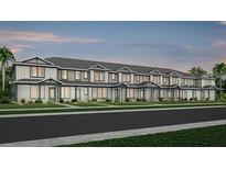 New townhome construction featuring classic architectural details and professionally landscaped front yards at 11344 Blue Bay Dr, Orlando, FL 32832