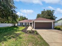 Charming single-story home with a well-manicured lawn and an inviting front entrance at 120 Marion Oaks Mnr, Ocala, FL 34473