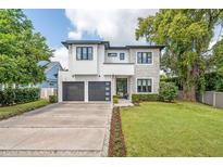 Striking two-story home with modern design, manicured lawn, and a spacious two-car garage at 2407 Lafayette Ave, Winter Park, FL 32789