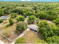 Expansive aerial view of a secluded single Gathering home on a wooded lot surrounded by mature trees at 2550 Barren Oak Ct, Deland, FL 32720