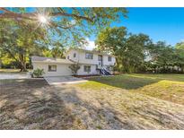Charming two-story home with lush landscaping and a sun-drenched front yard at 2550 Barren Oak Ct, Deland, FL 32720