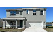 Charming two-story home showcasing a modern gray exterior, white trim, and a two-car garage at 279 Wisteria Ct, Deltona, FL 32738