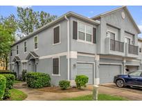 Well-maintained townhome exterior featuring neutral paint, shutters, attached garage, and manicured landscaping at 2810 San Jacinto Cir # 2810, Sanford, FL 32771