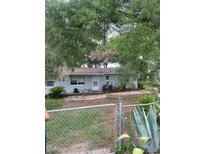 Charming single-story home with mature trees and a fenced yard for added privacy and curb appeal at 3600 Ne 22Nd Ct, Ocala, FL 34479