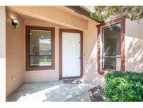 Inviting front entrance with a white door, brown trim, and well-kept landscaping for a welcoming first impression at 4643 Fern Pine Dr, Orlando, FL 32808