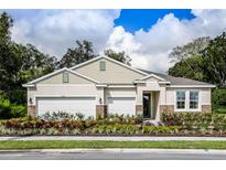 Charming one-story home with a three car garage, stone accents, manicured landscaping, and a welcoming entrance at 5740 Cool Spring Cv, St Cloud, FL 34771