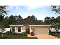 Charming single-story home featuring a two-car garage, manicured lawn, and beautifully landscaped front yard at 6055 Vision Rd, St Cloud, FL 34771