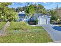 Charming single-story home with a fenced yard, freshly painted exterior, and well-manicured landscaping at 642 Carver Dr, Lake Wales, FL 33853