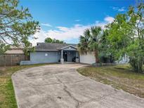 Charming single-story home with blue exterior paint, star decor, driveway, and well-maintained landscaping at 8606 Port Said St, Orlando, FL 32817