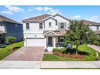 Charming home with a brick driveway and front porch seating at 1123 Dora Parc Ln, Mount Dora, FL 32757