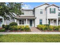 Charming two-story home featuring a well-manicured lawn and inviting front porch at 14538 Orchid Island Dr, Orlando, FL 32827