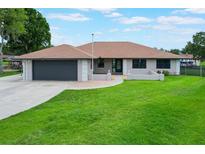 Charming single-story home with a well-maintained lawn and inviting curb appeal on a sunny day at 1620 Texas Ct, Tavares, FL 32778