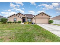 Charming single-story home featuring a well-maintained lawn, landscaping and an attached two car garage at 186 Nw 44Th St, Ocala, FL 34475