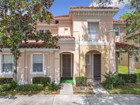Charming townhome with a red tile roof and manicured landscaping at 2662 Mayaguana St, Kissimmee, FL 34747